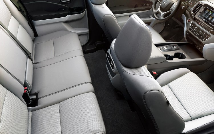 2026 Honda Ridgeline RTL with gray leather interior, showing rear and front seats.